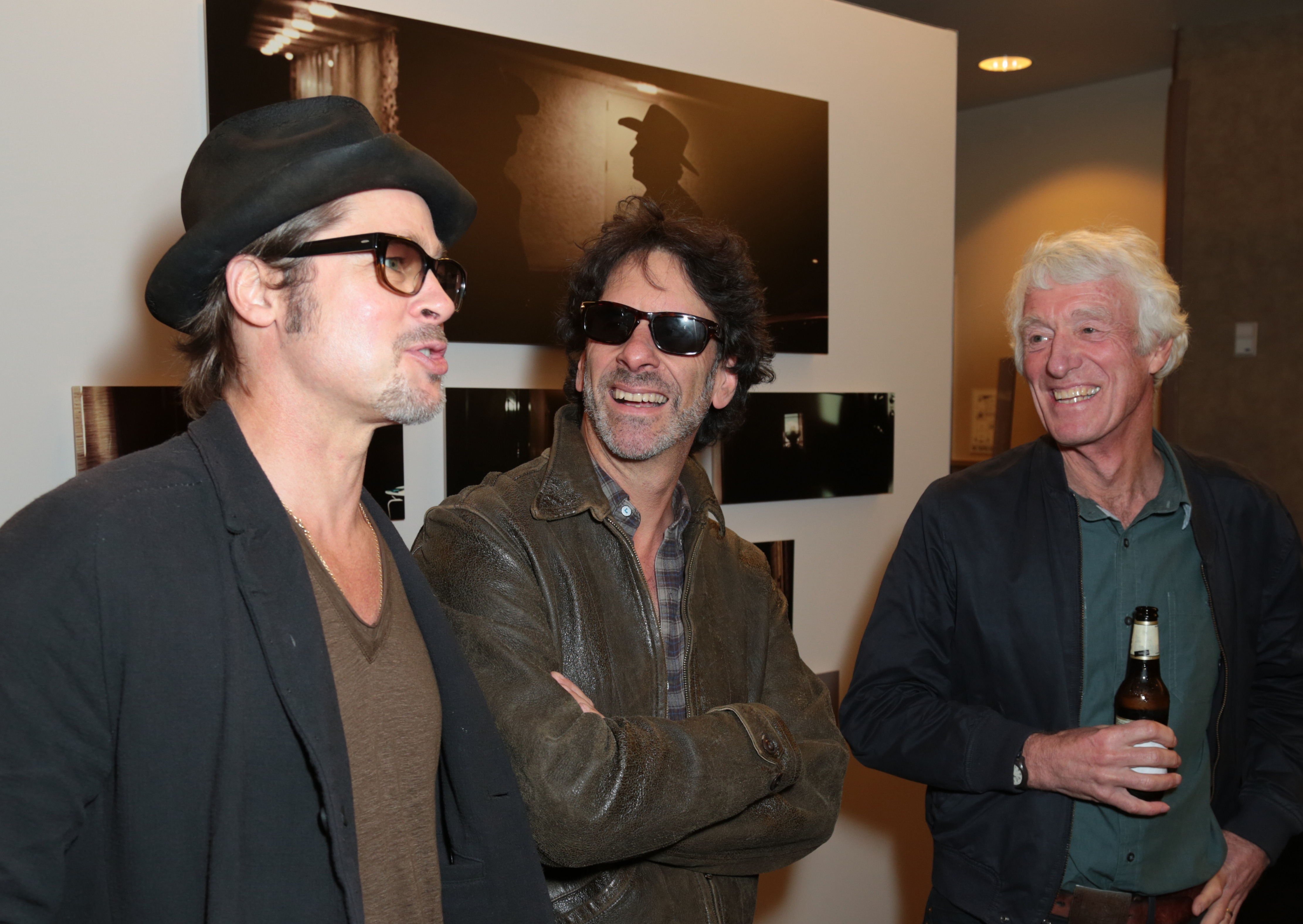 From left: Brad Pitt, Joel Coen and Roger Deakins mingle at the opening reception for Roger Deakins: Persistent Vision.