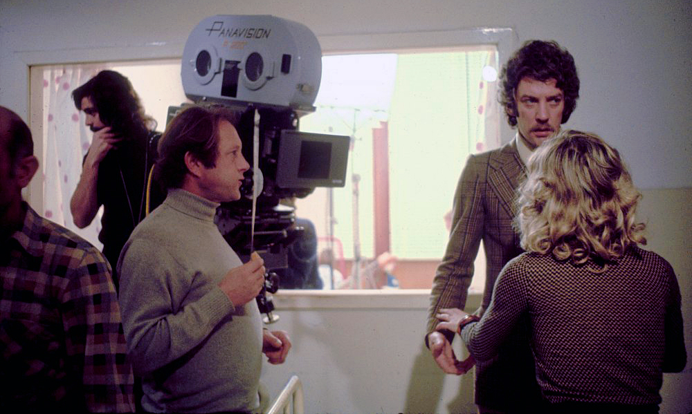 On the set of Don't Look Now (1973) are (from left) cinematographer Tony Richmond, director Nicholas Roeg and actors Donald Sutherland and Julie Christie.