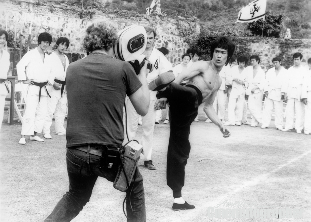 Plotting out the action for a fight between actor John Saxon and tai-chi master Bolo Yeung, Lee demonstrates a kick directly into Hubbs’ handheld lens for Saxon (partly obscured by the camera magazine).