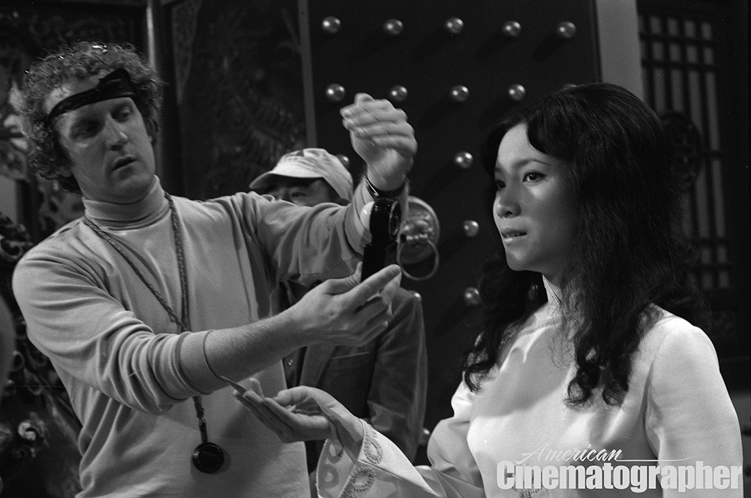 Hubbs sets his light on actress Betty Chung while shooting the banquet scene.