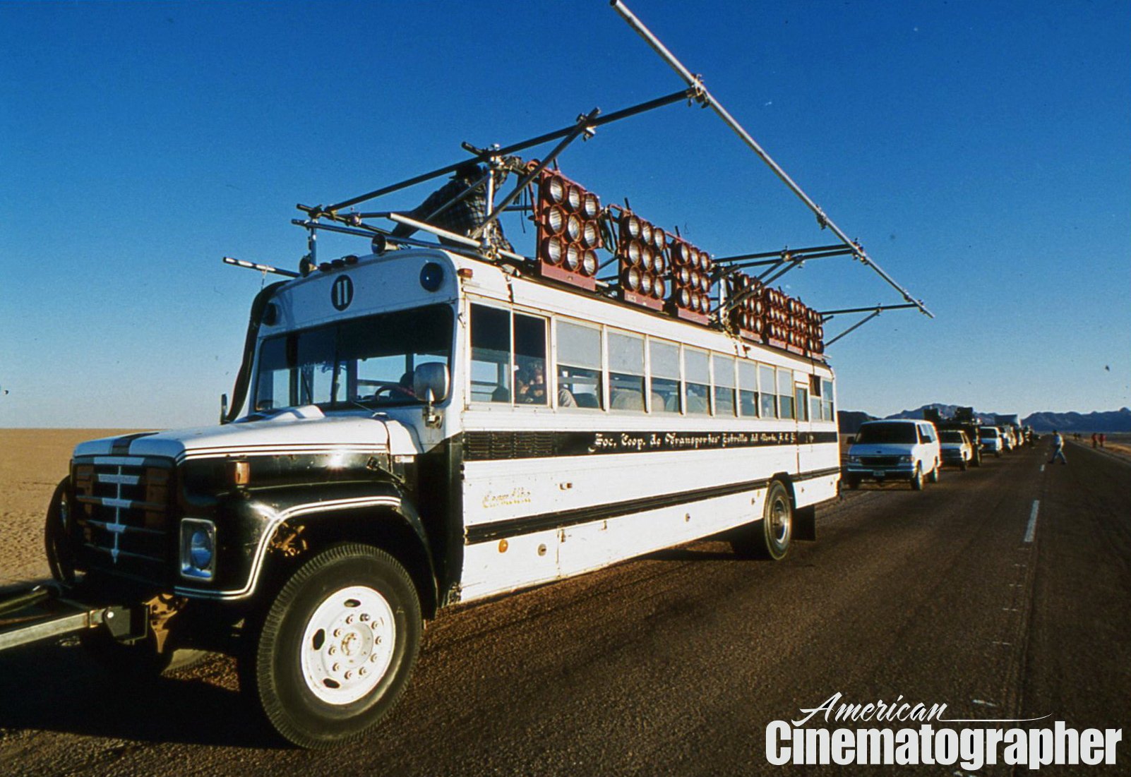 Setting up the bus rig, with the production caravan stretching into the background.