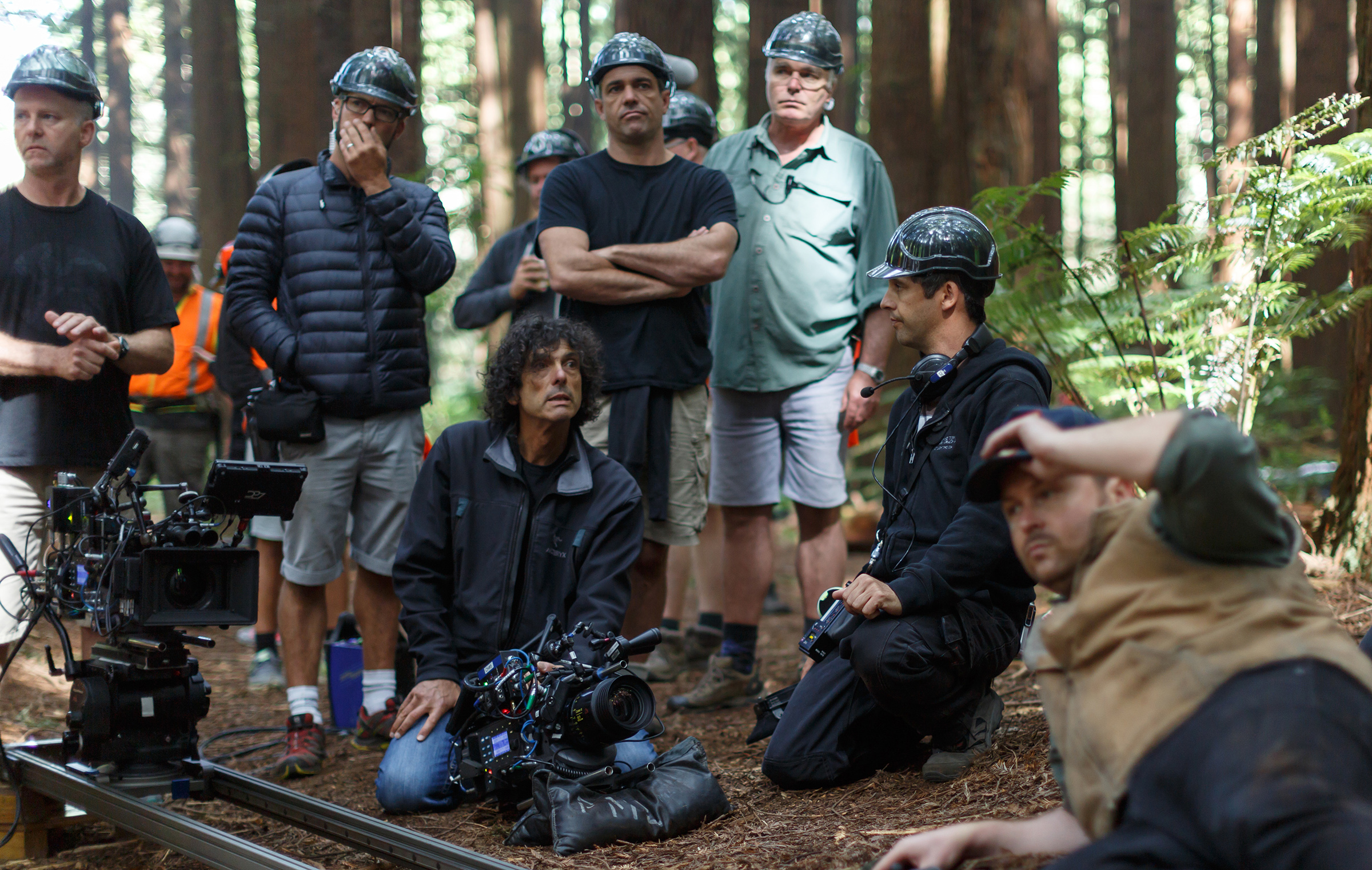 Director David Lowery and cinematographer Bojan Bazelli, ASC (kneeling) on the set of Disney's Pete's Dragon.