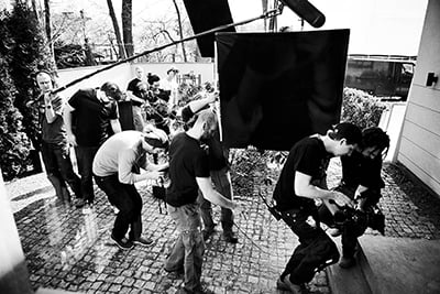 Jakub “Kuba” Kijowski, PSC (second from right, holding camera) on set. 